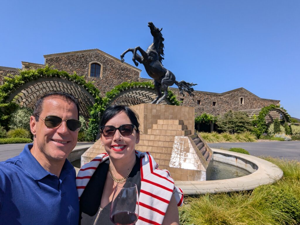 A couple enjoying a cabernet sauvignon in front of Black Stallion Winery, Napa